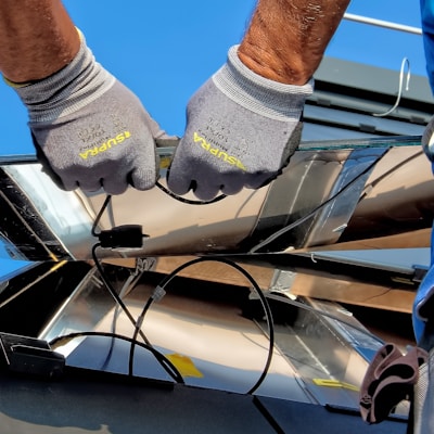 two men carrying a metal sheet