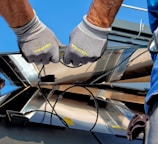 two men carrying a metal sheet