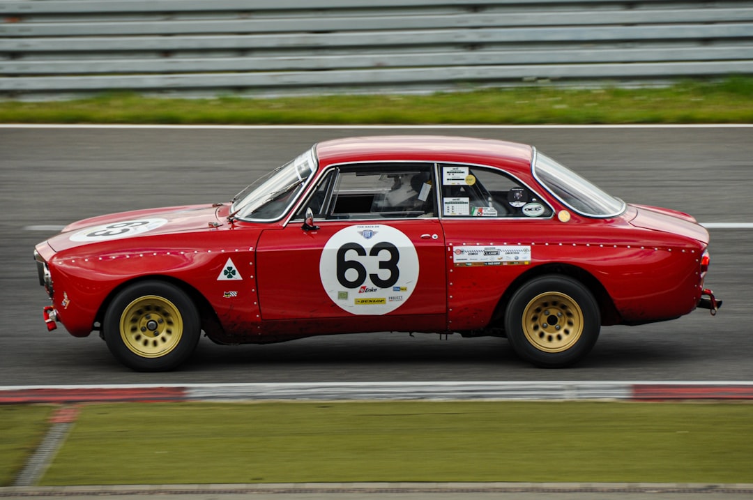 Red Alpha Romeo classic car on a race track - digital marketing guide - Photo by Jan Ivo Henze | best digital marketing - London, Bristol and Bath marketing agency