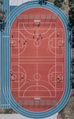 A spacious playground with teenagers engaging in sports.