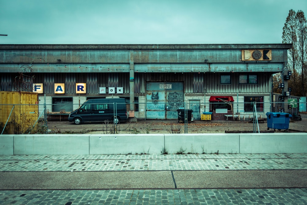 landscape photography of van parked in front of a building