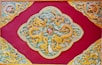 yellow, beige, and red dragon print textile