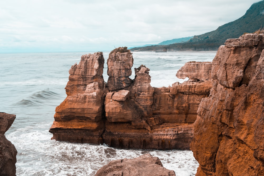 brown rocky cliff in beach