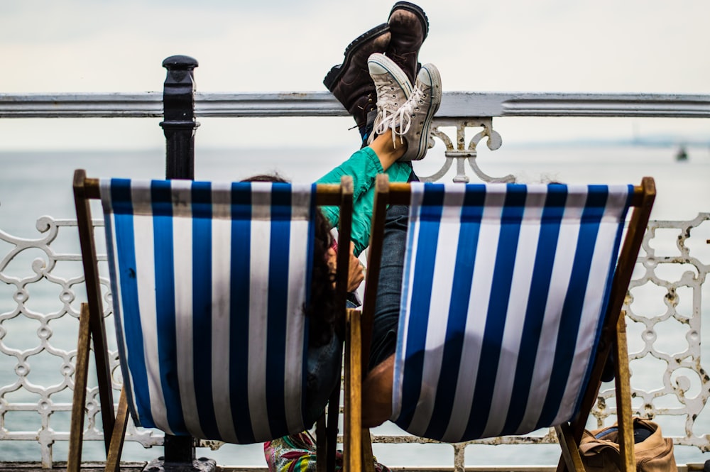 two blue-and-white deck chairs