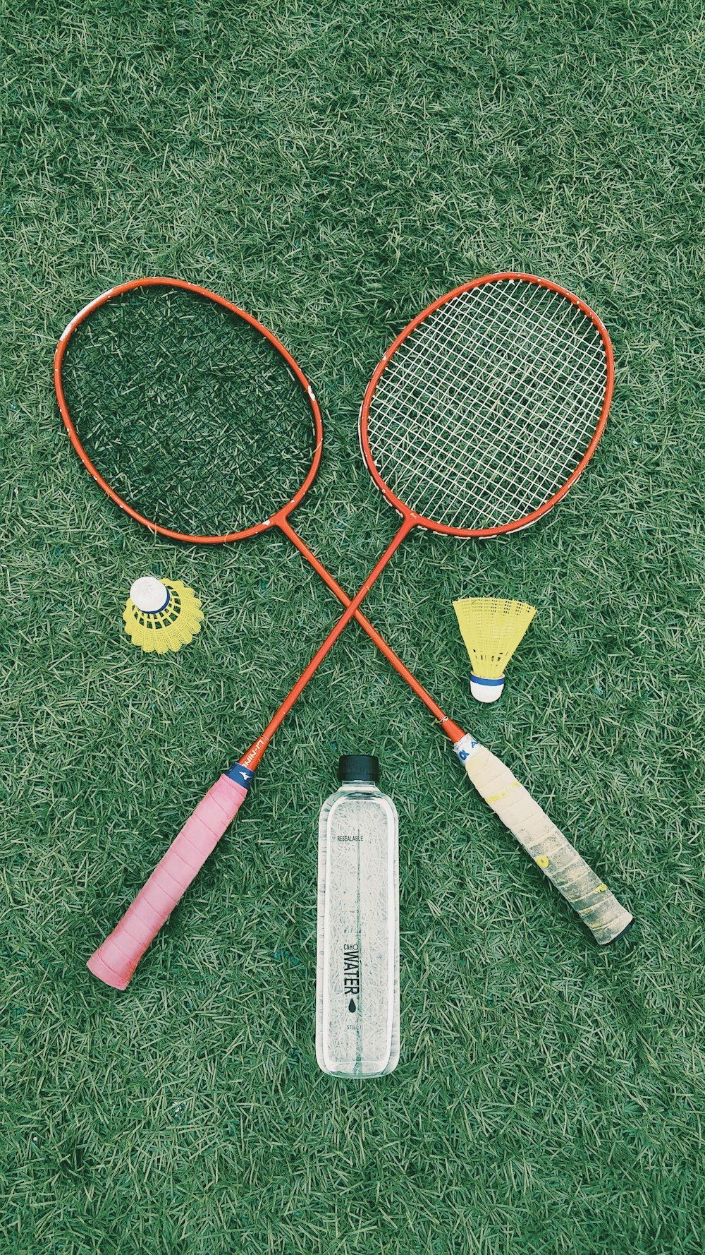 pair of red badminton rackets