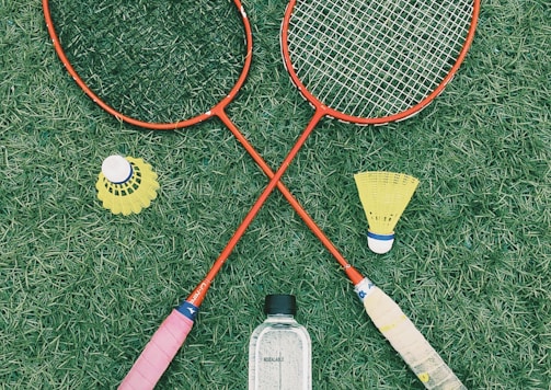 pair of red badminton rackets