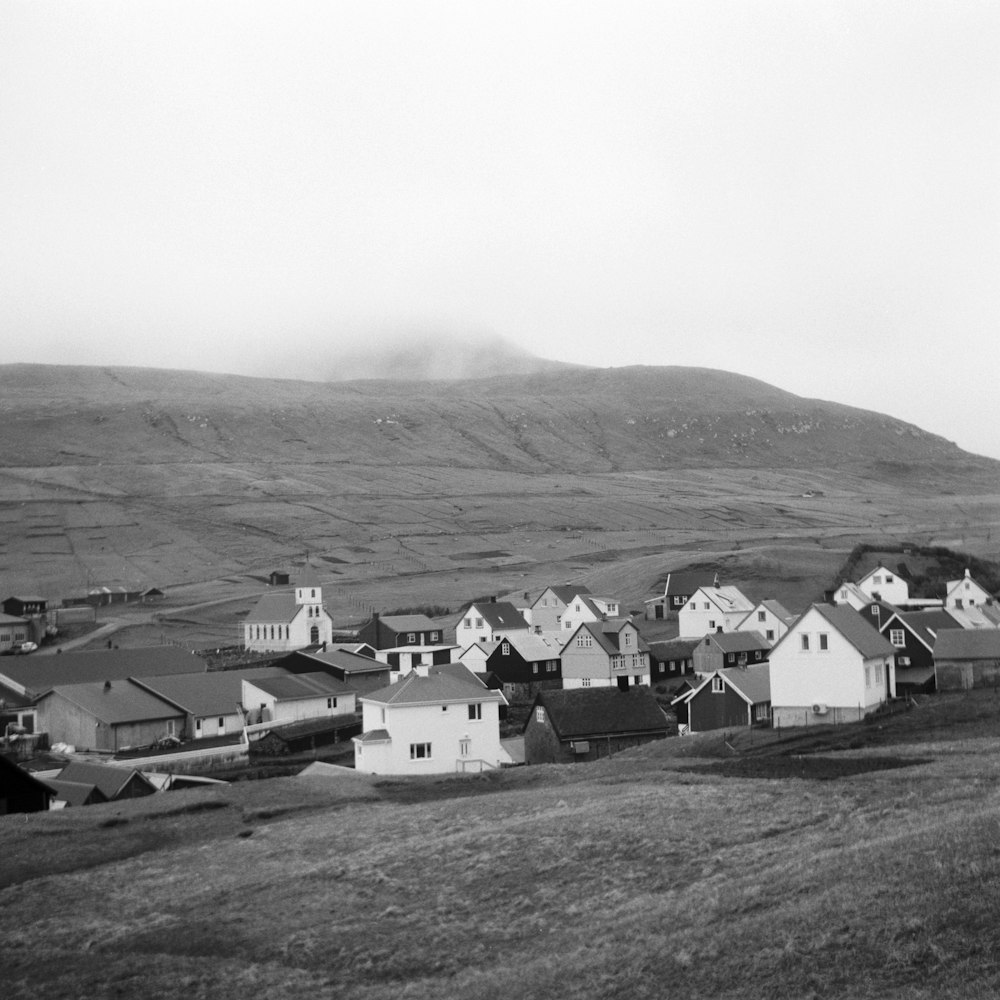 grayscale photography of houses on field