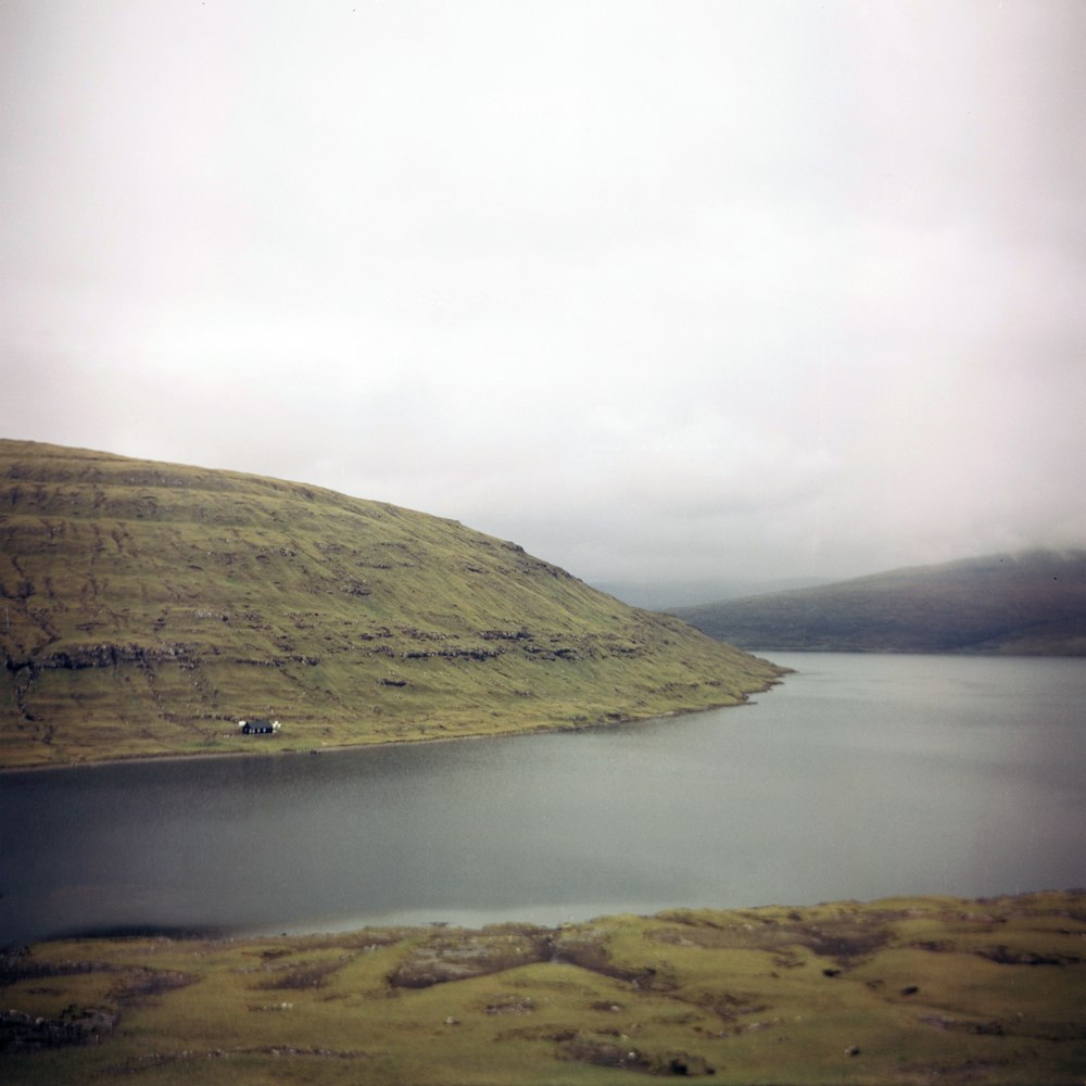 river beside mountain during daytime