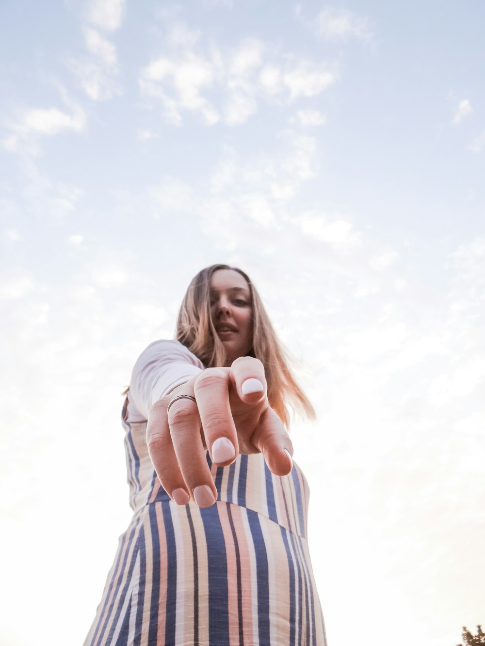 woman in beige and blue striped dress