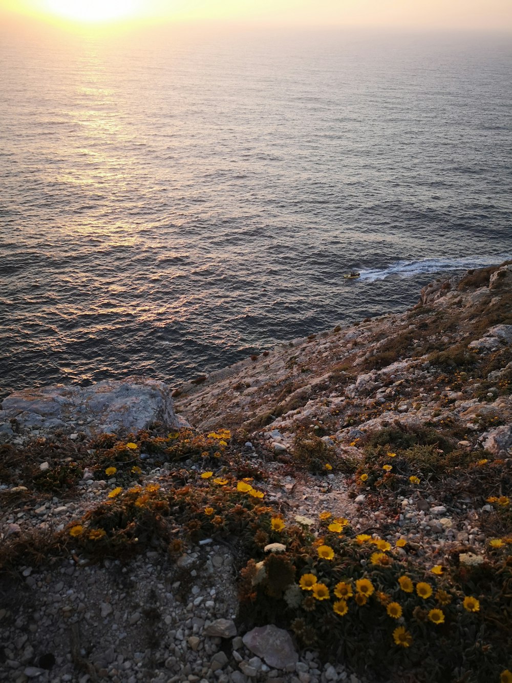 body of water beside rock formation