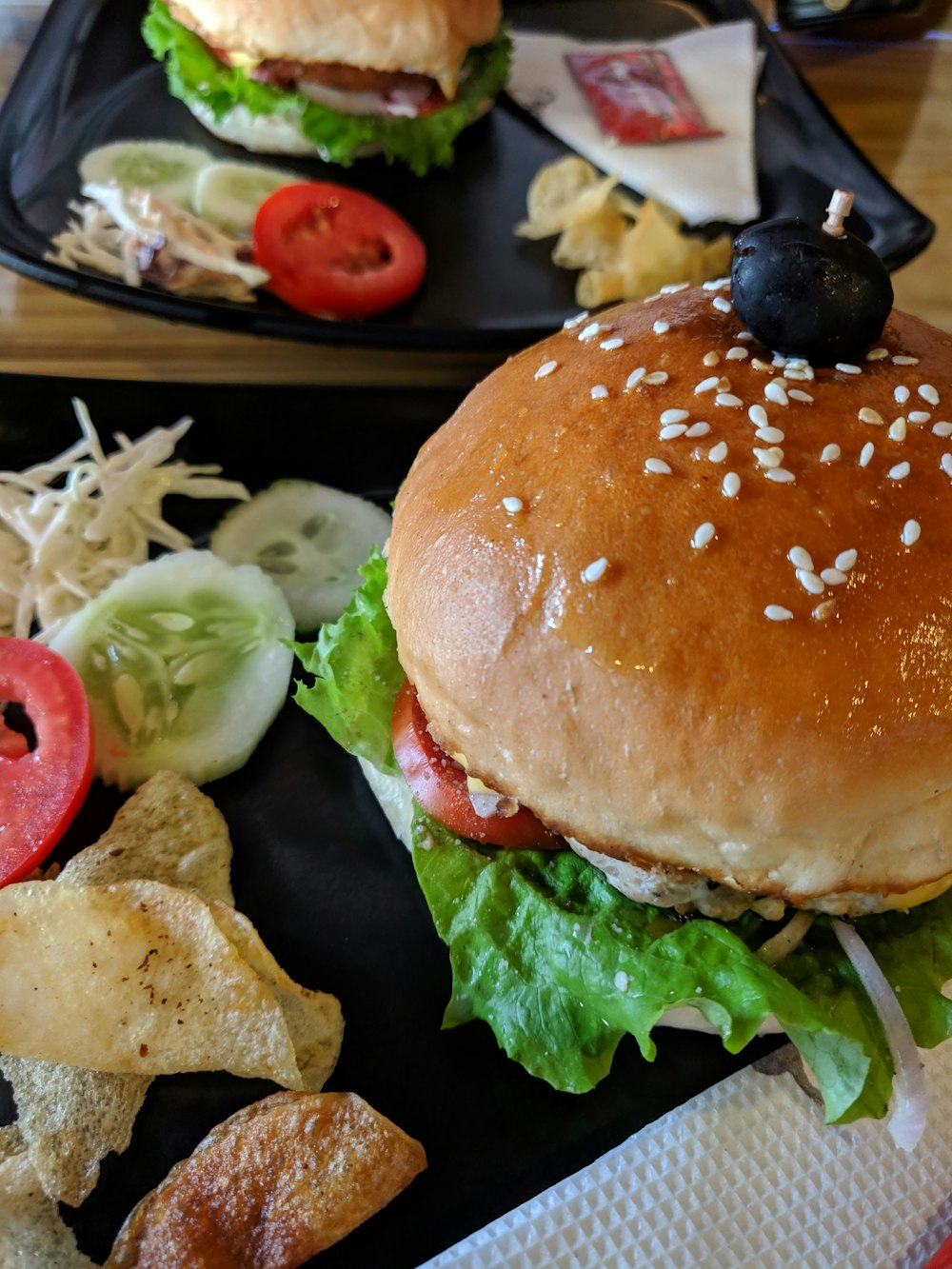 hamburger with vegetables beside fruits