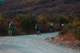 cyclist travelling on gravel trail by the mountain
