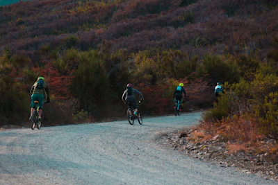 cyclist travelling on gravel trail by the mountain