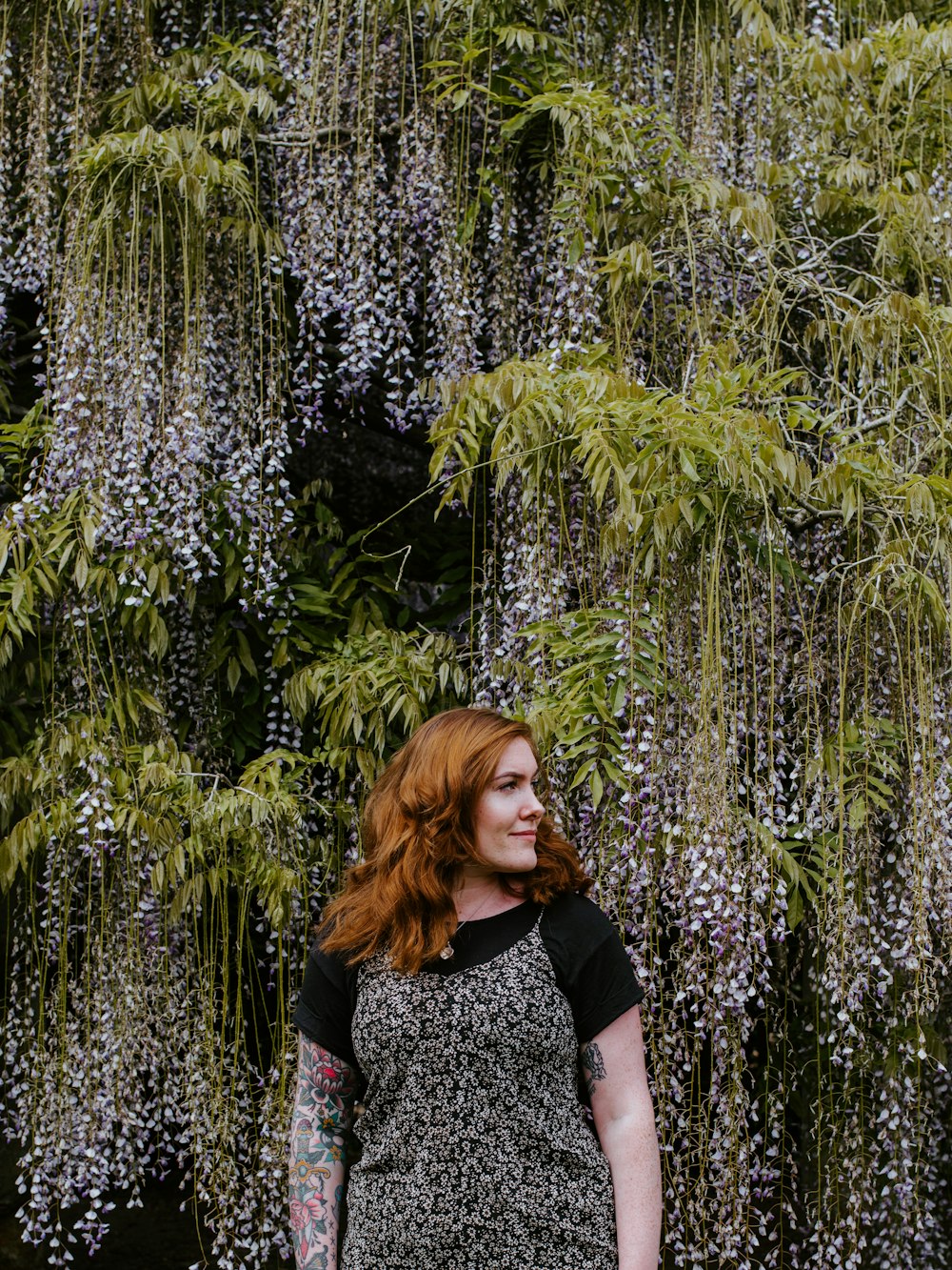 woman standing near flowers