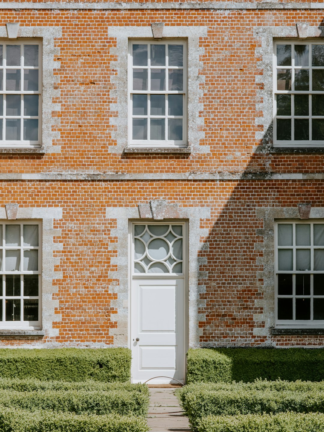 green hedge in front of building facade