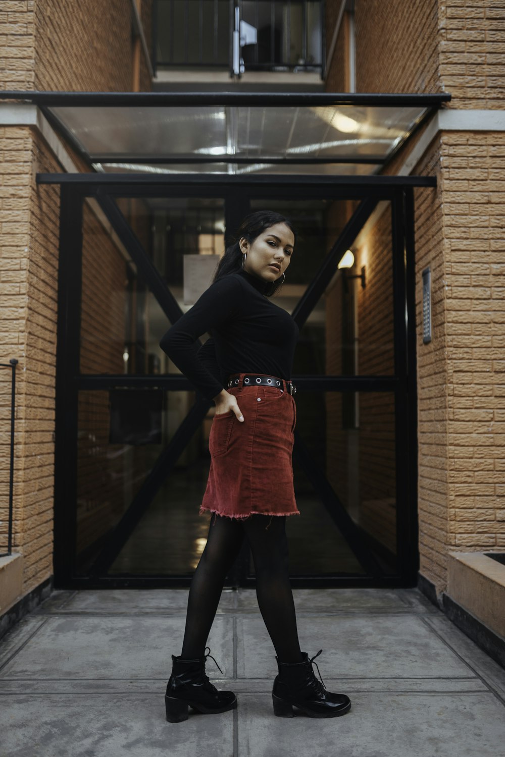 woman standing in front of glass door