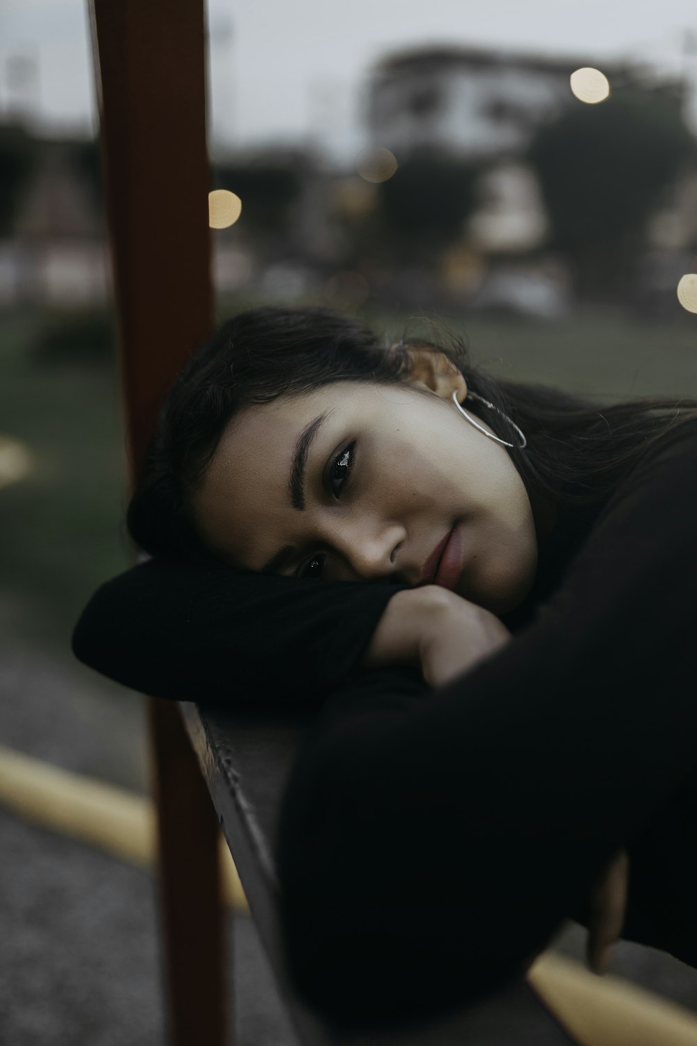 woman lies on bench