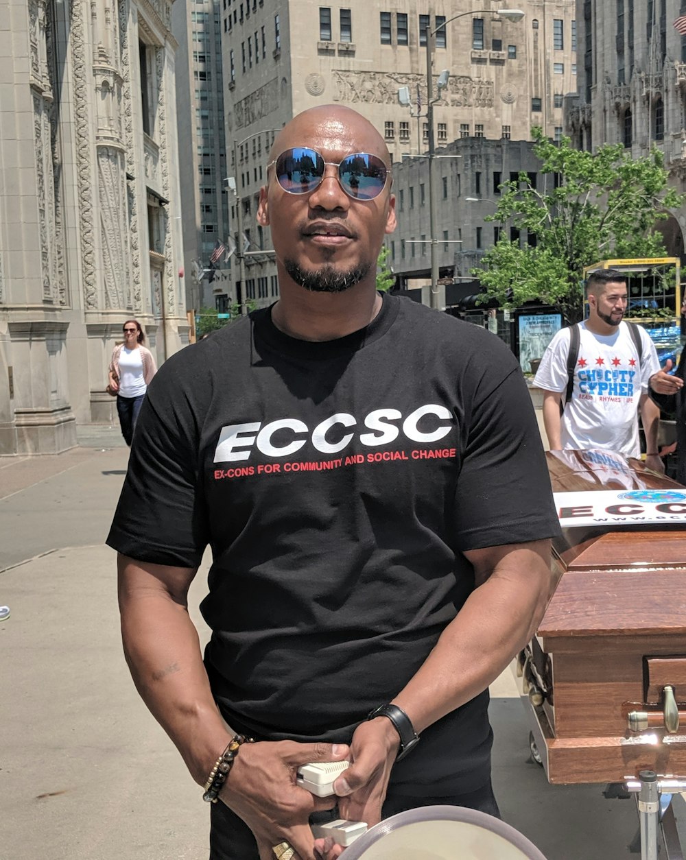 man in black Eccsc crew-neck t-shirt standing near coffin