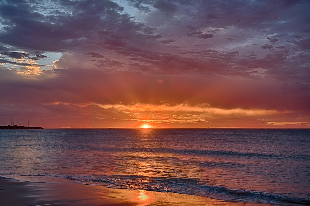 body of water during sunset