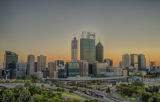 A sleek and modern urban skyline highlighting sustainable infrastructure projects by Yard Infra at sunset.