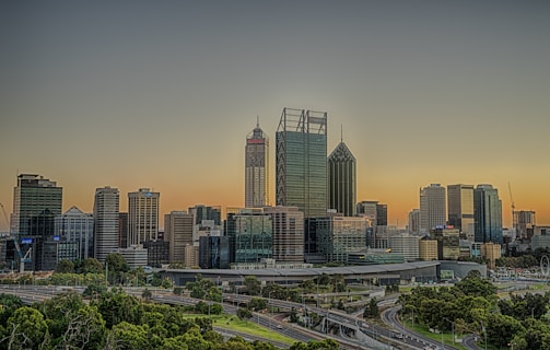 A sleek and modern urban skyline highlighting sustainable infrastructure projects by Yard Infra at sunset.
