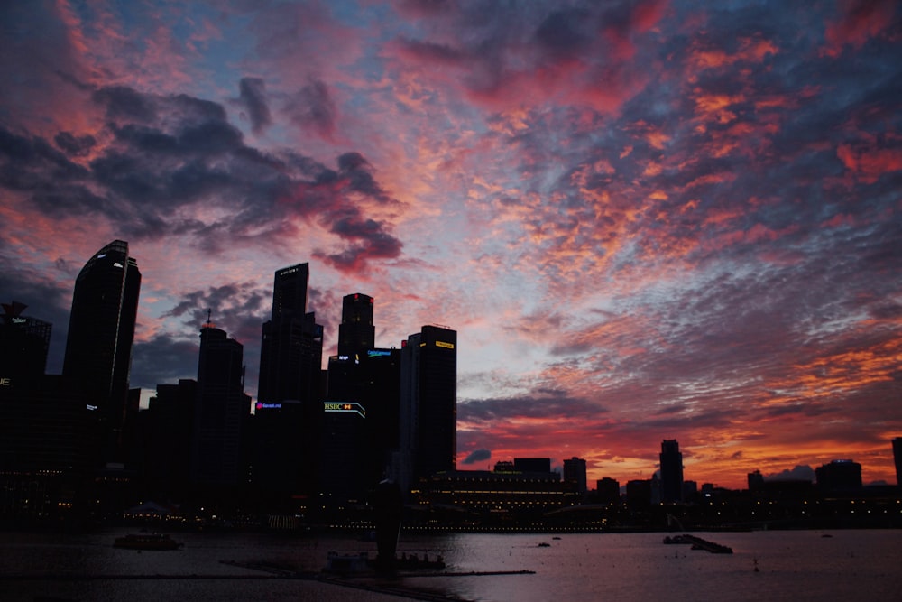 silhouette of high-rise buildings under orange skies