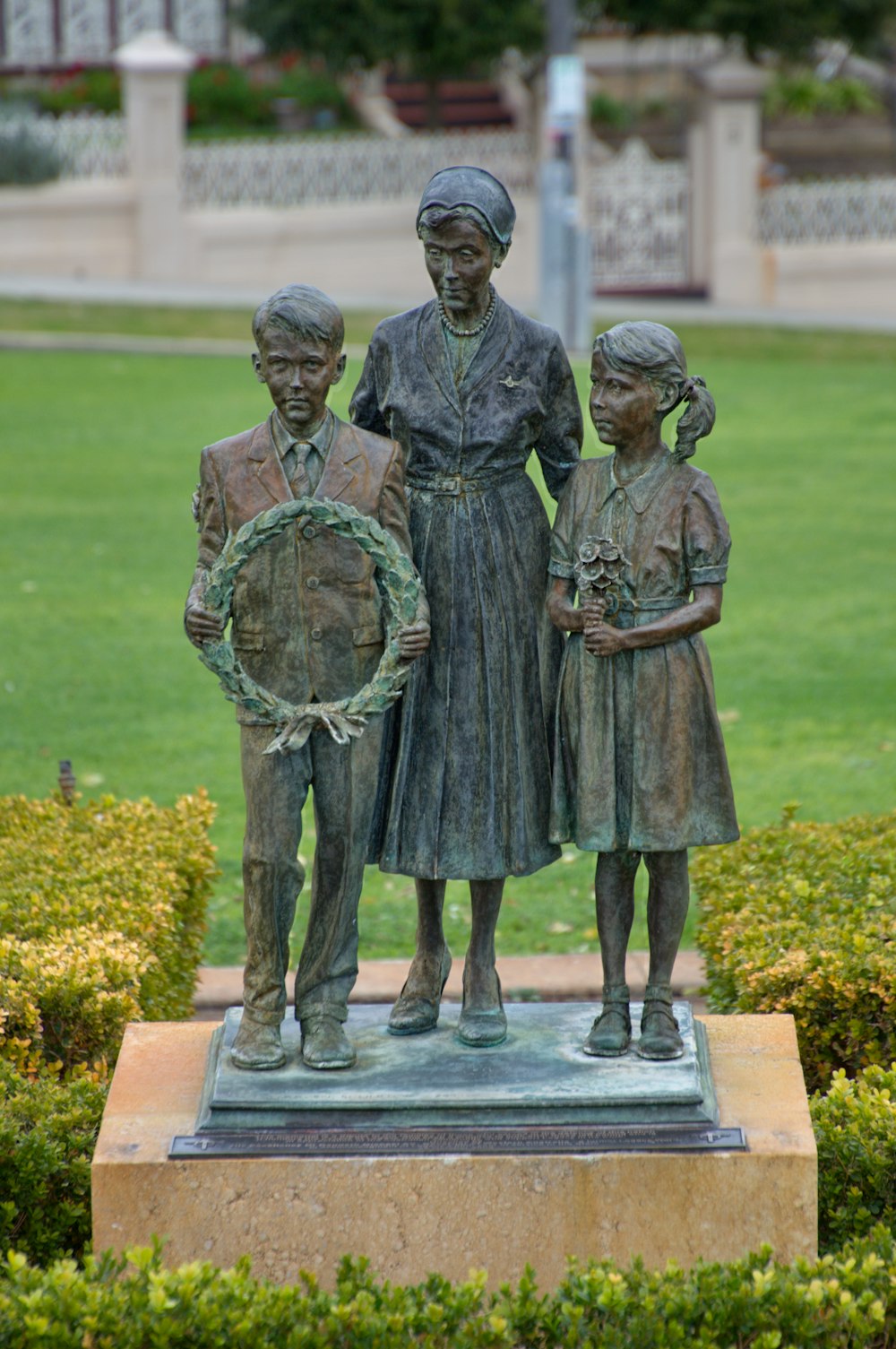 woman between girl and boy statue