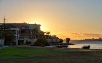 A serene Naples waterfront neighborhood at sunset showcasing elegant homes and palm trees