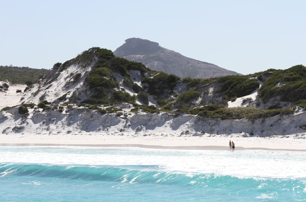 two people walking at beach