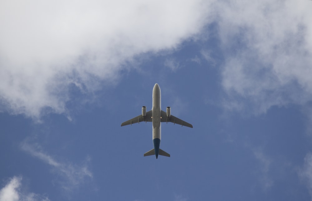 white and gray airplane mid air