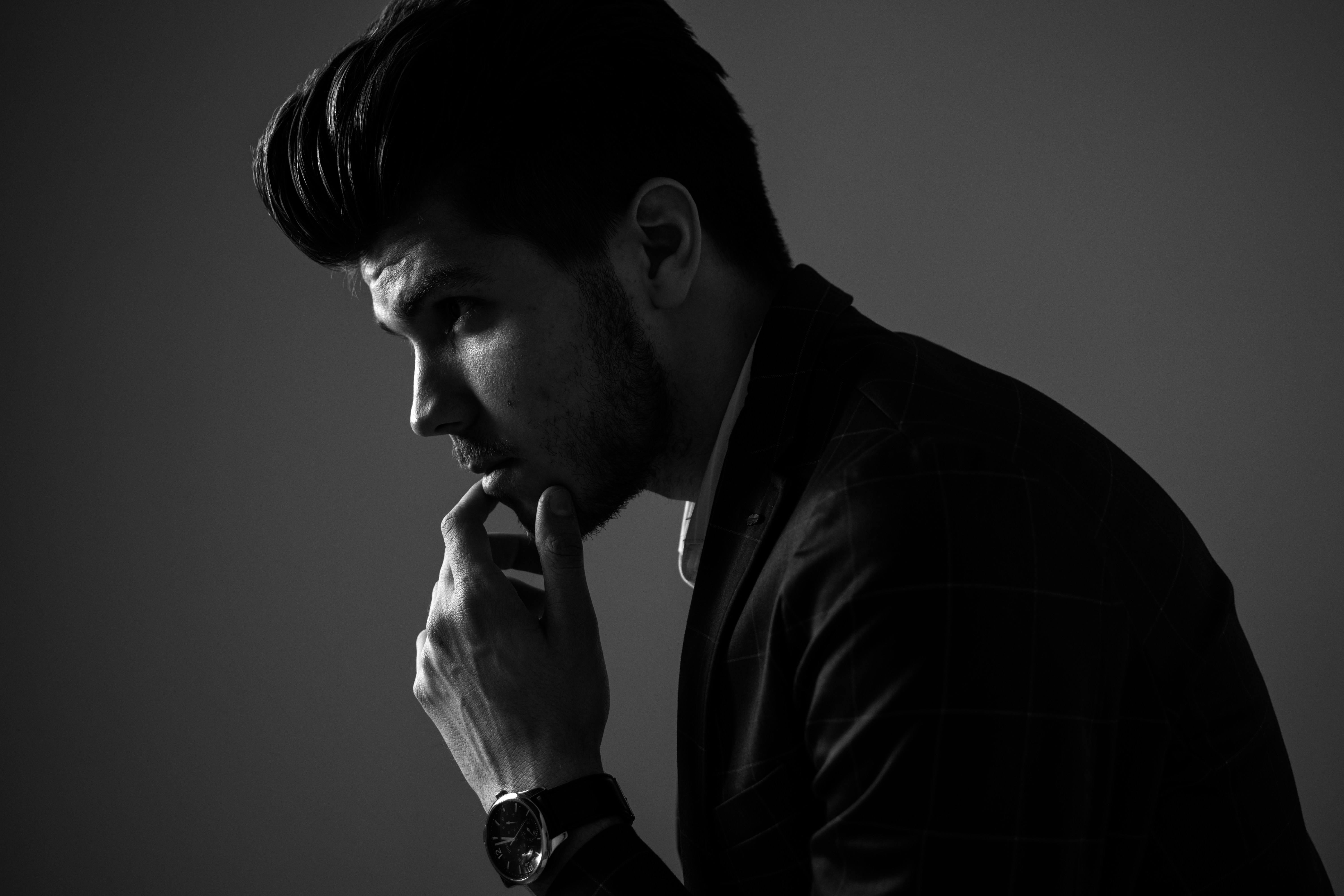 grayscale photography of man wearing blazer