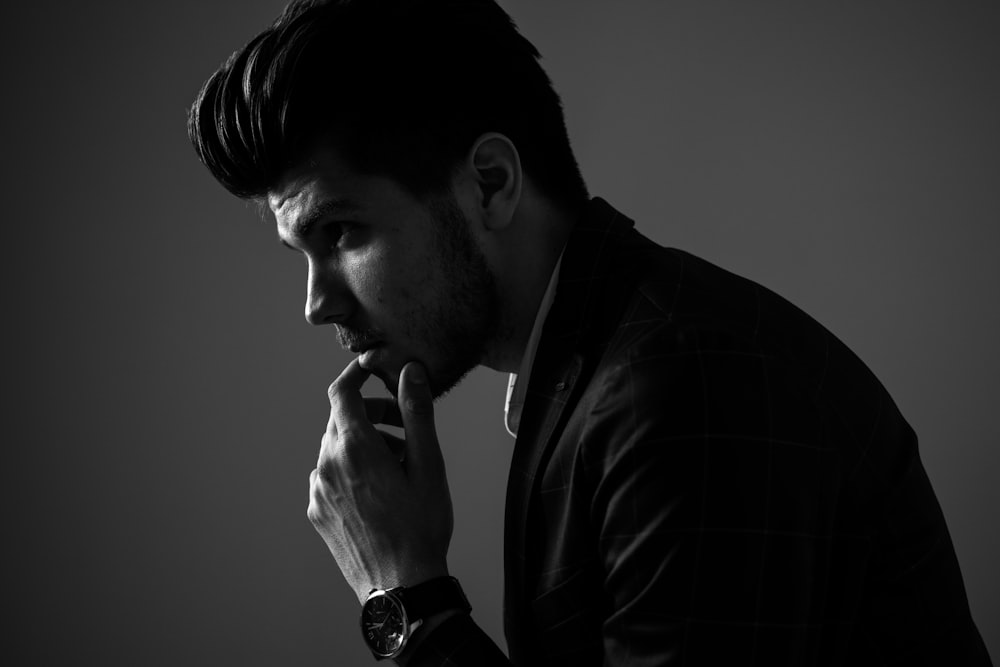 grayscale photography of man wearing blazer