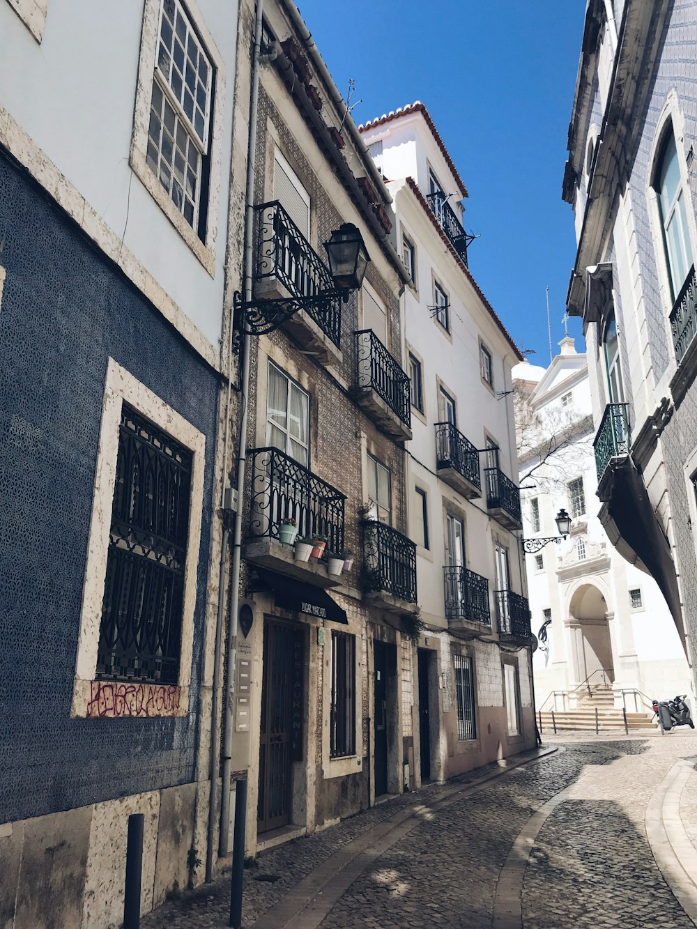 a narrow street with several buildings and balconies