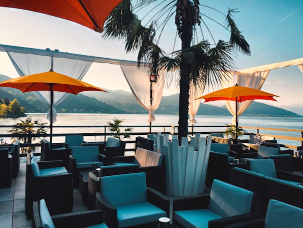 Hotel terrace overlooking the lake with guests enjoying breakfast outdoors