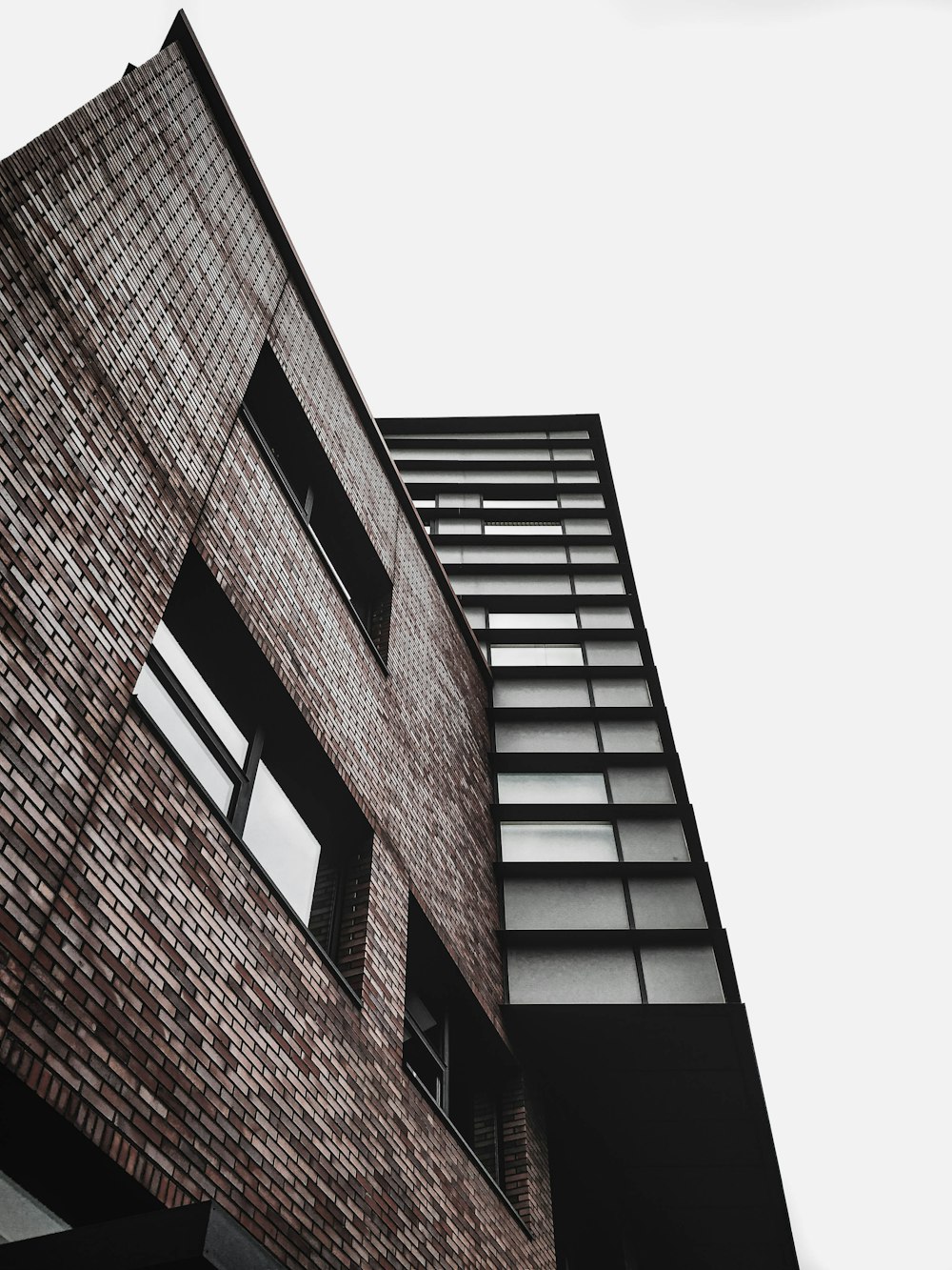 a tall brick building next to a tall building