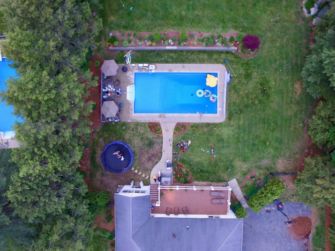 Aerial view of a residential home with a backyard swimming pool