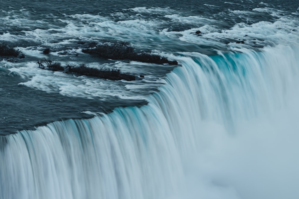 a large waterfall with water flowing over it