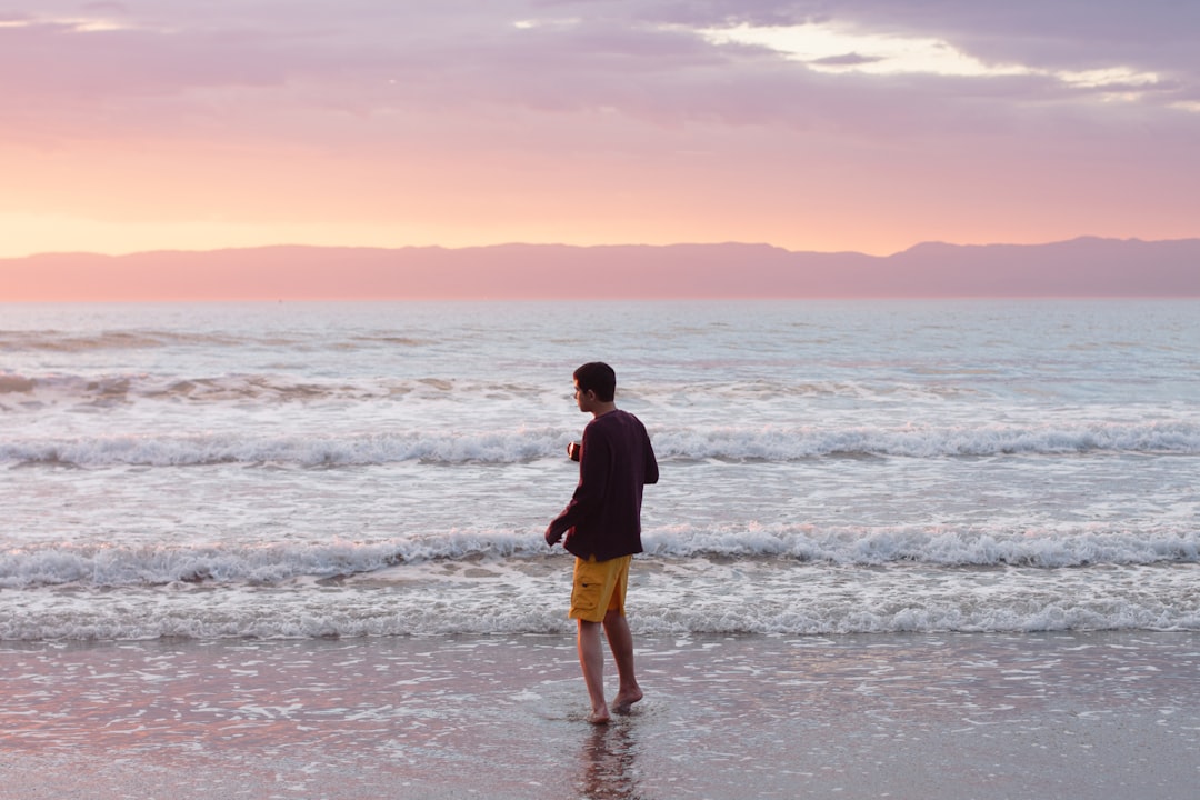 man standing on sesashore