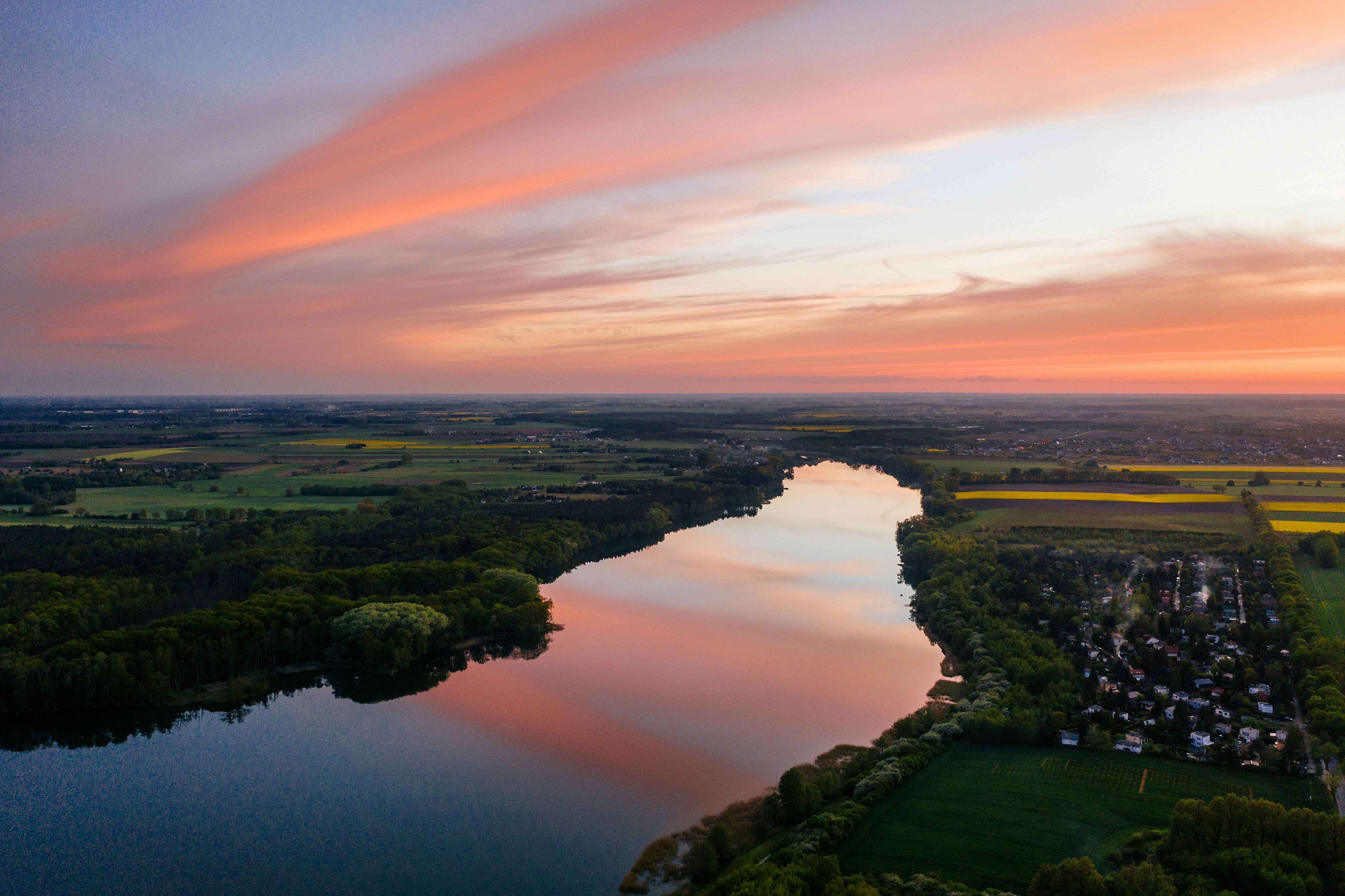 aerial photography of river beside city during golden hour