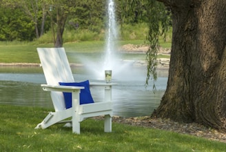 Classic Adirondack chair nestled among green plants, perfect for serene afternoons.
