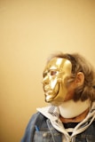 person wearing gold mask