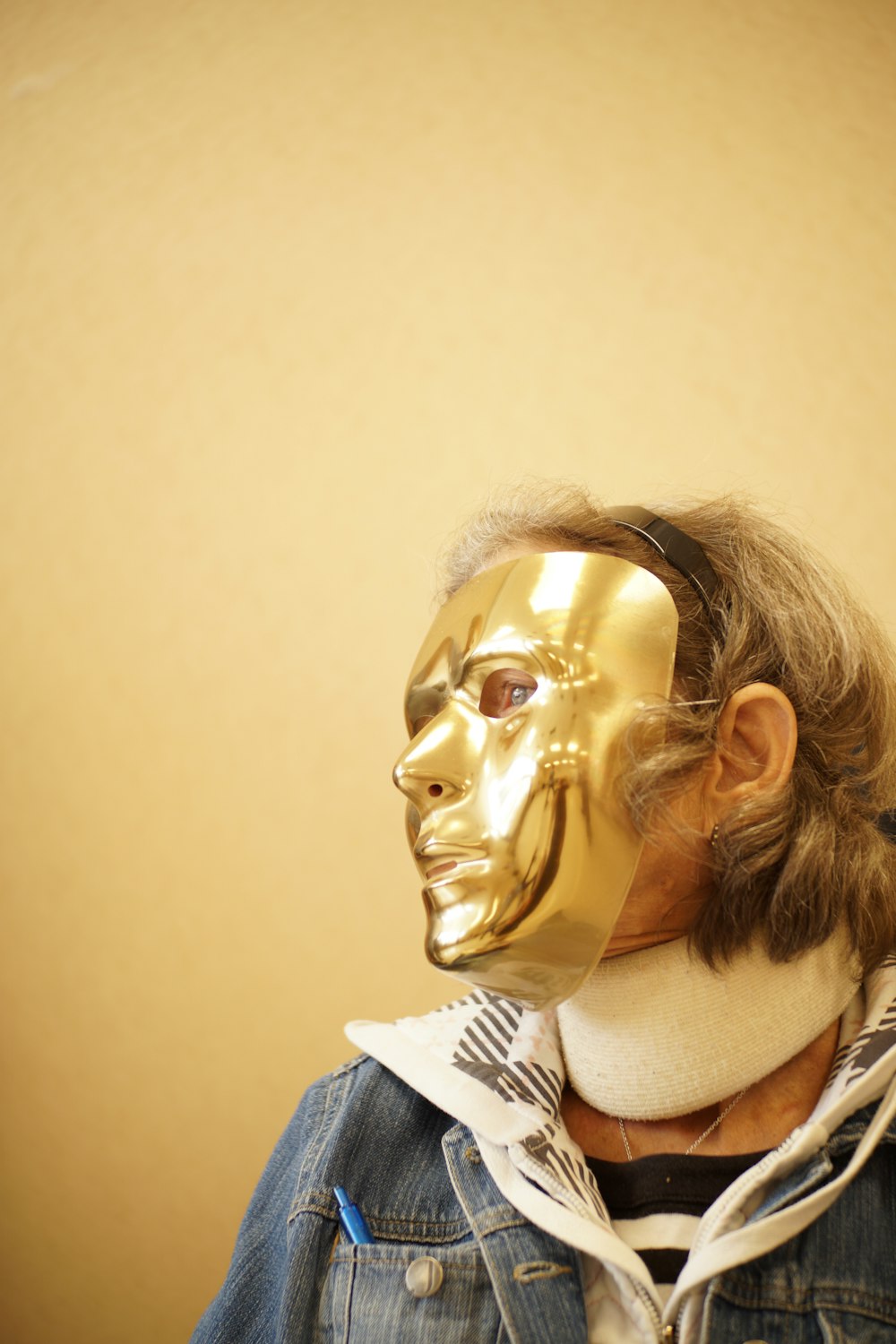 person wearing gold mask