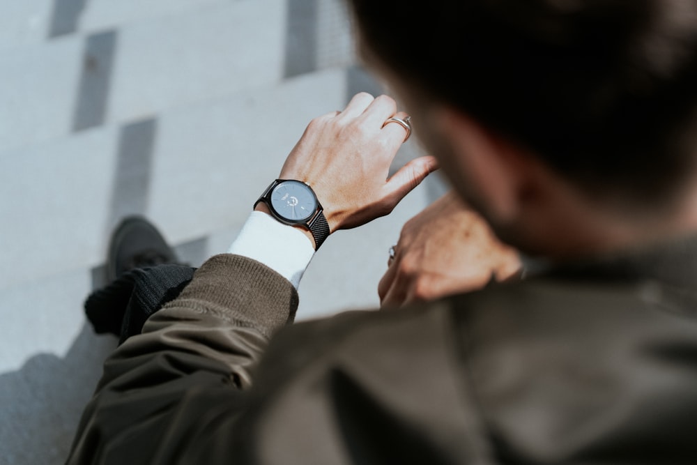 man looking at watch on left wrist