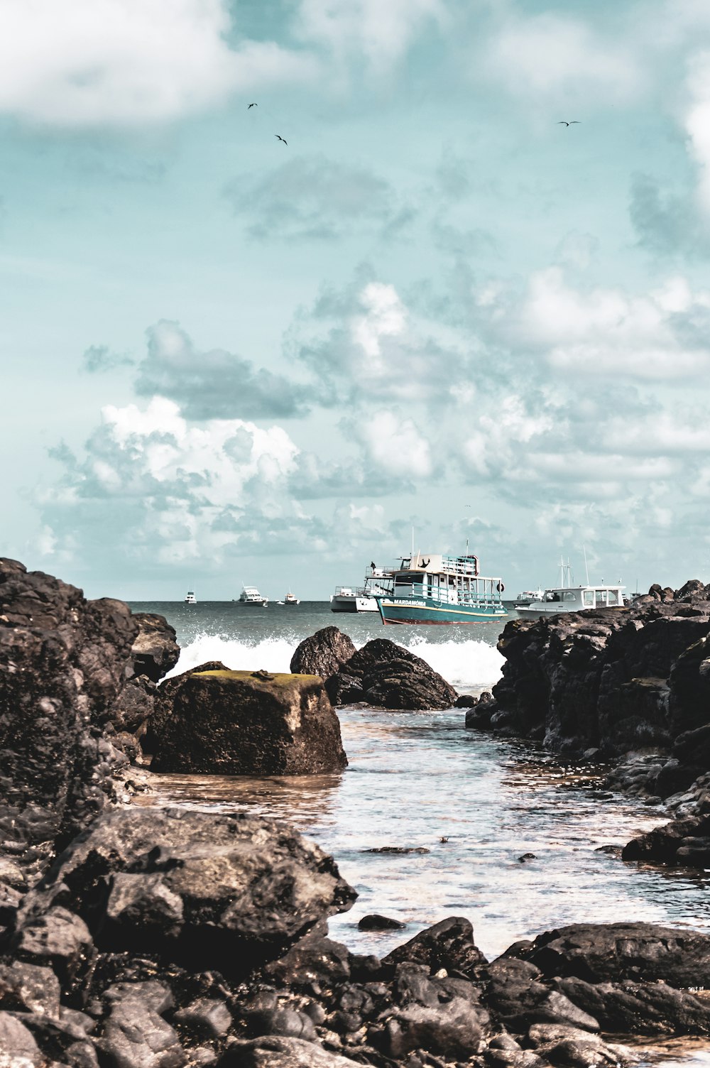 vessel on body of water under cloudy sky