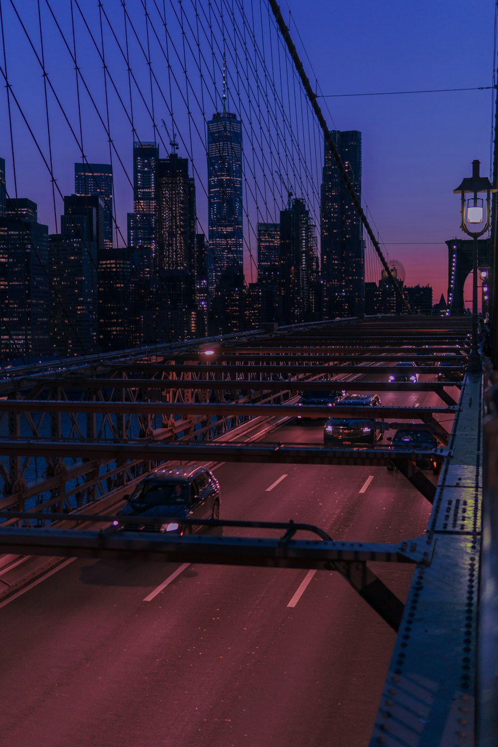 several vehicles on bridge during night time