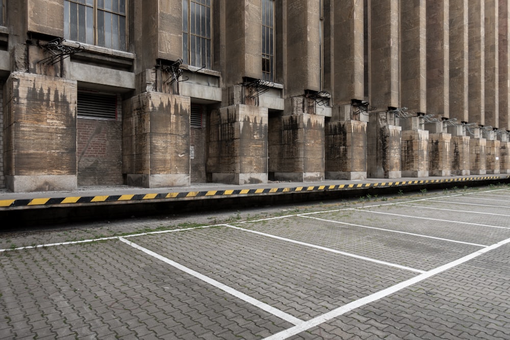 an empty parking lot in front of a large building