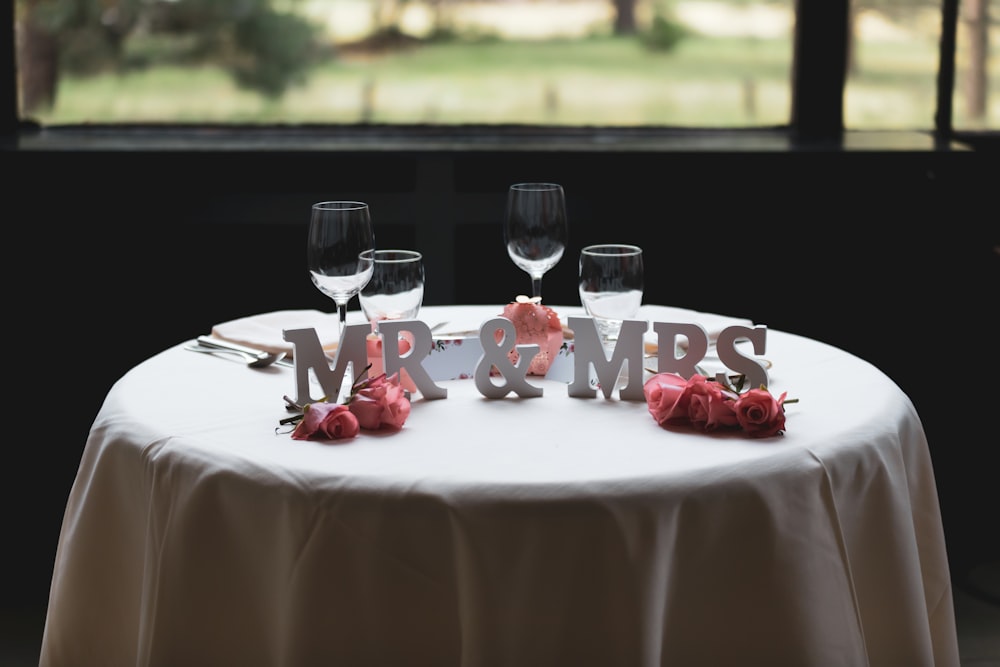 Lettre autoportante Mr & Mrs sur table avec quatre verres à vin