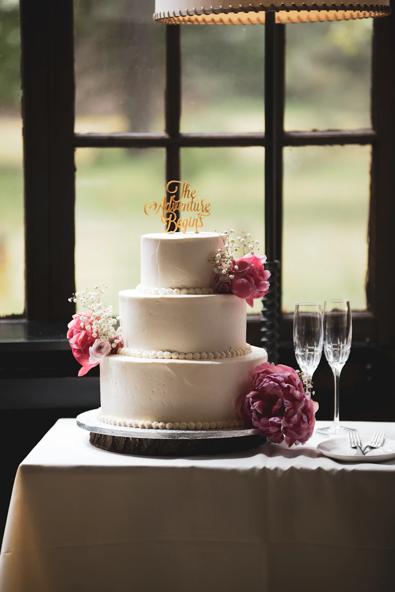Wedding cake display beside the barn dessert table