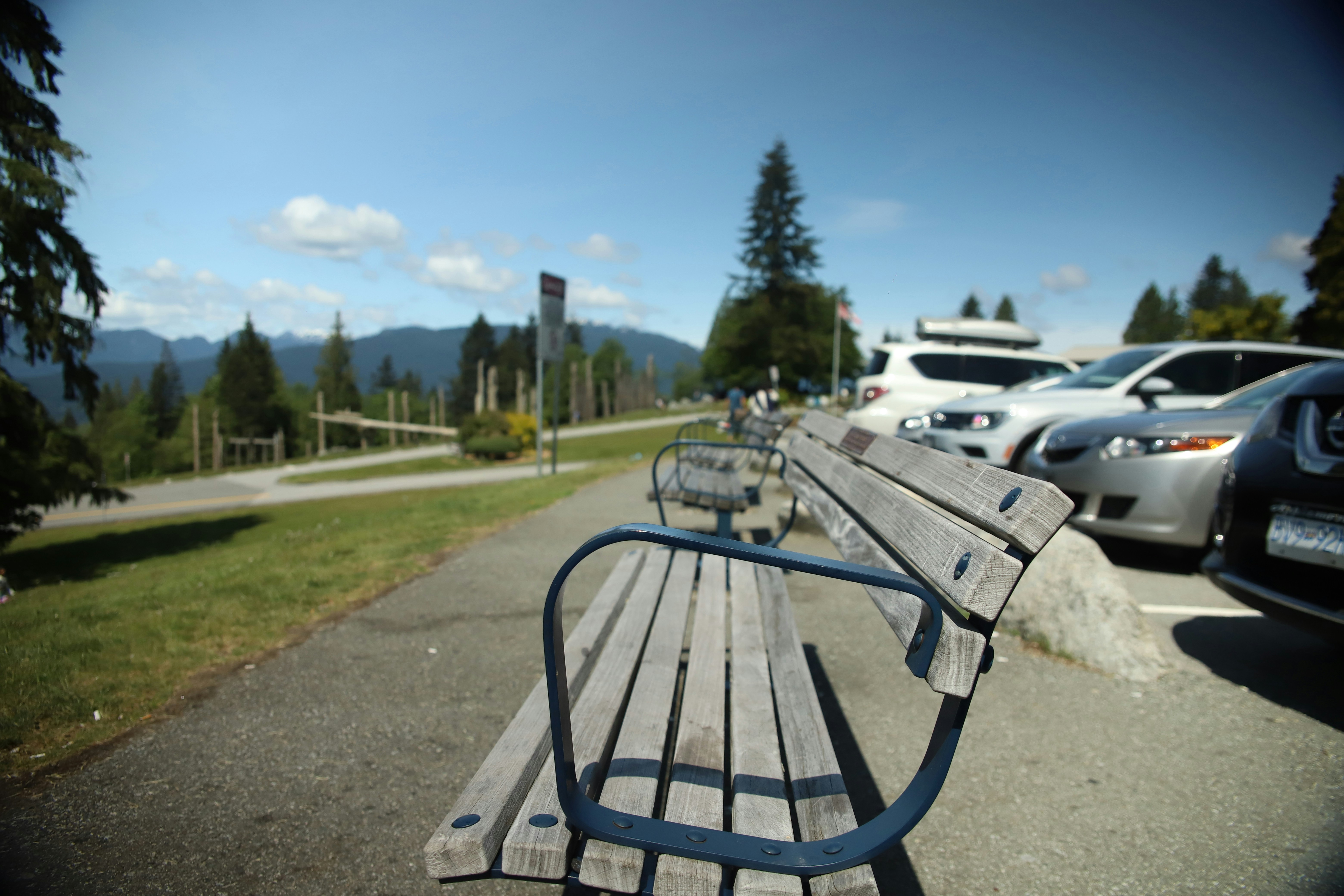brown and black bench near cars