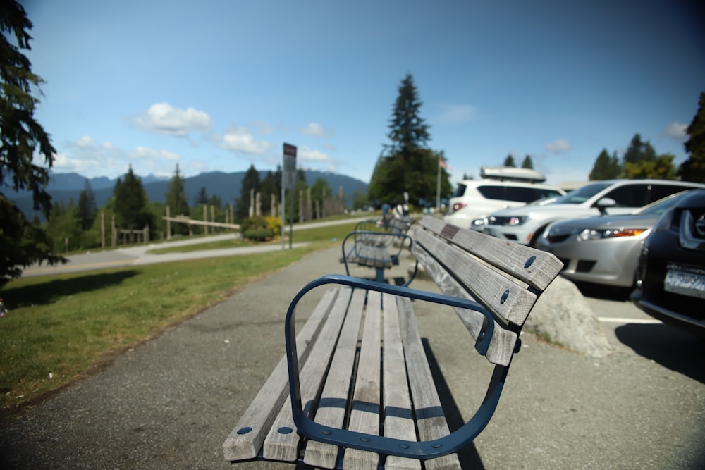 brown and black bench near cars